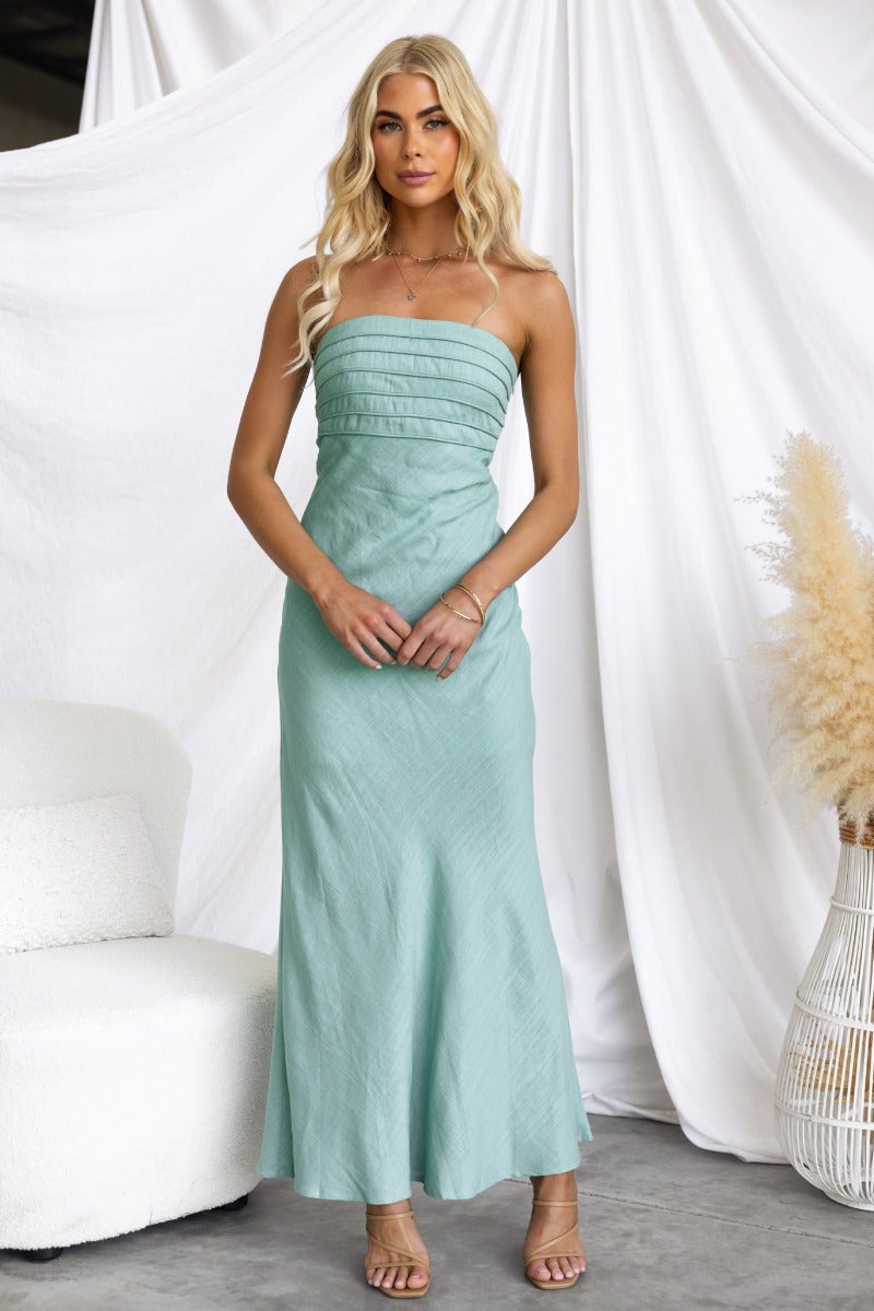 Model wearing a strapless linen blend Wilder Maxi Dress in mint green, showcasing its elegant fit and stylish design.