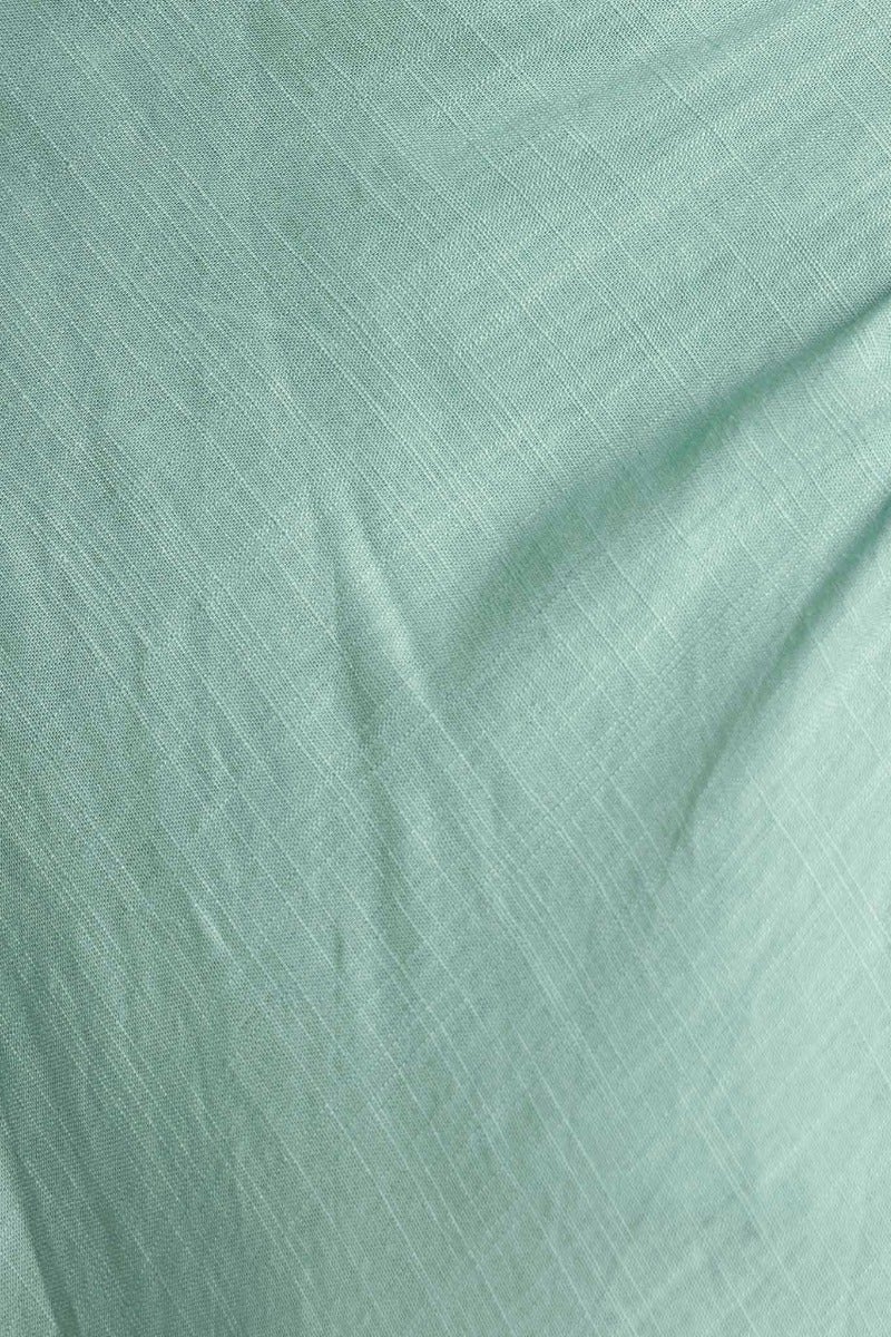 Close-up of soft, textured mint green fabric, ideal for stylish apparel like the Wilder Maxi Dress.