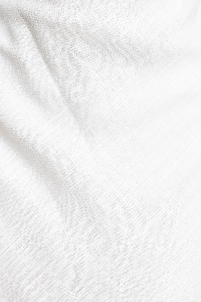 Close-up of lightweight linen fabric in white, showcasing texture and softness for Wilder Maxi Dress.