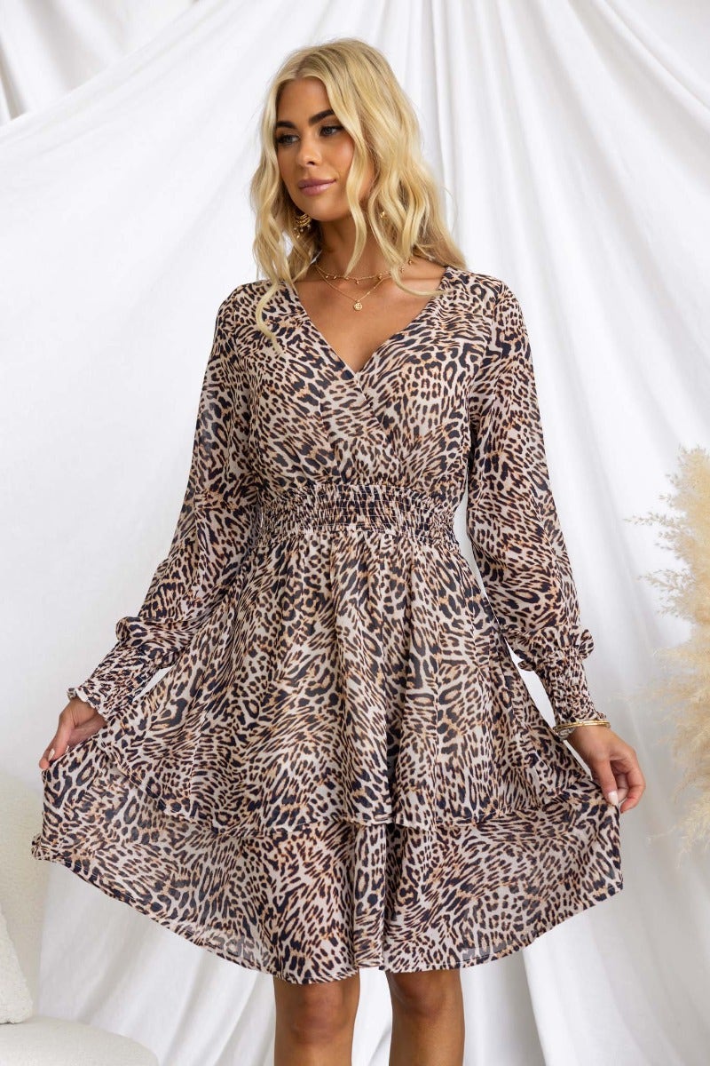 Caralina Dress: animal print V-neck dress with elastic sleeves, lined, and standard fit, worn by model with blonde hair.