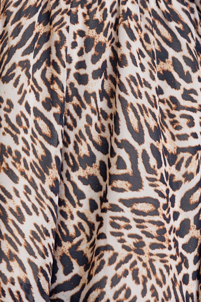 Close-up of animal print fabric featuring a stylish leopard pattern in neutral tones, ideal for the Caralina Dress.