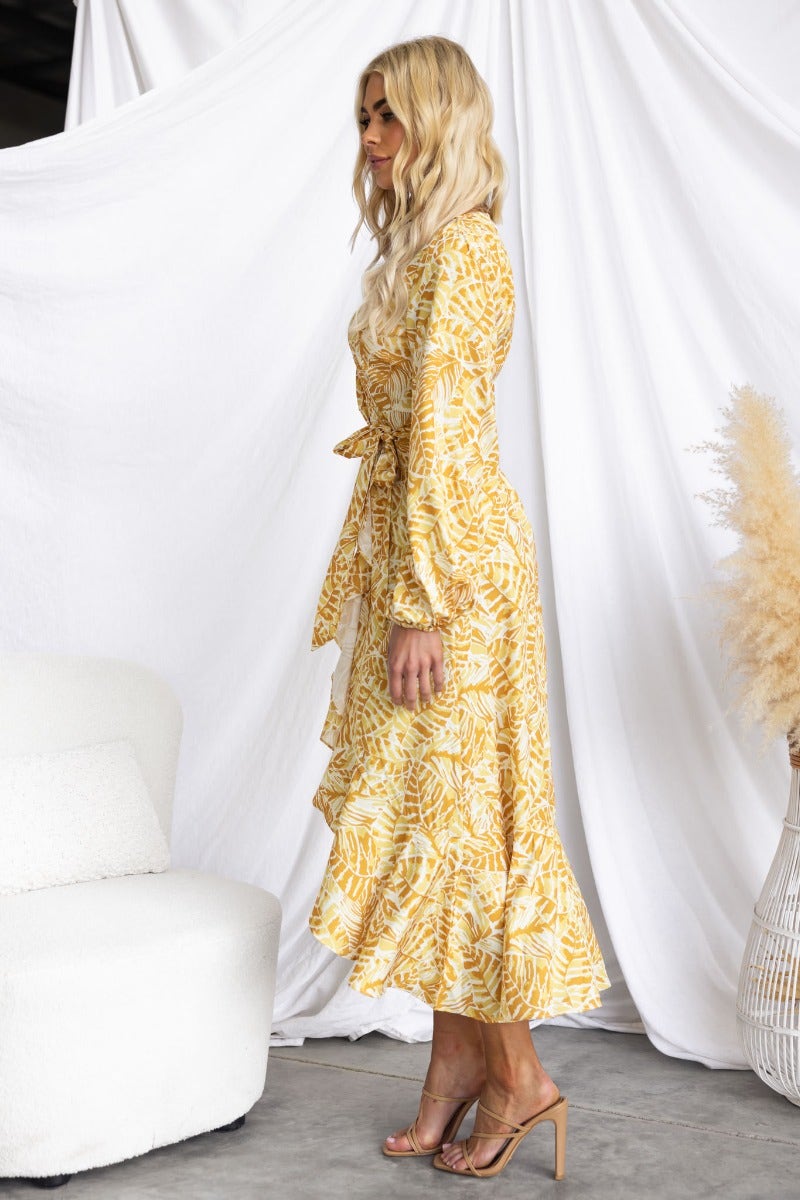 Kemble Midi Dress in vibrant yellow print with ruffled hem, featuring a removable belt and elastic cuffs.