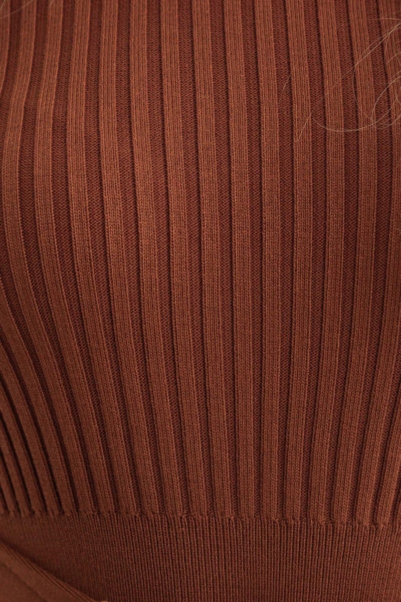 Close-up of ribbed brown fabric texture of the Drew Midi Dress, showcasing its stretch and design details.