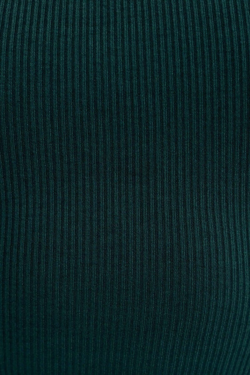 Close-up of ribbed knit fabric in deep green, showcasing texture and stretch for the Buckley Midi Dress.
