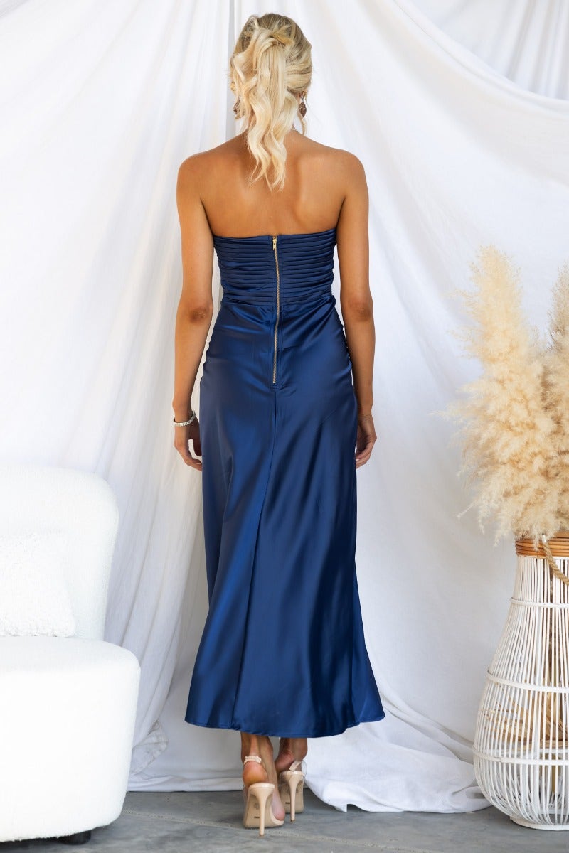 Back view of a navy strapless Zadora maxi dress with a zip closure and ruched detailing.