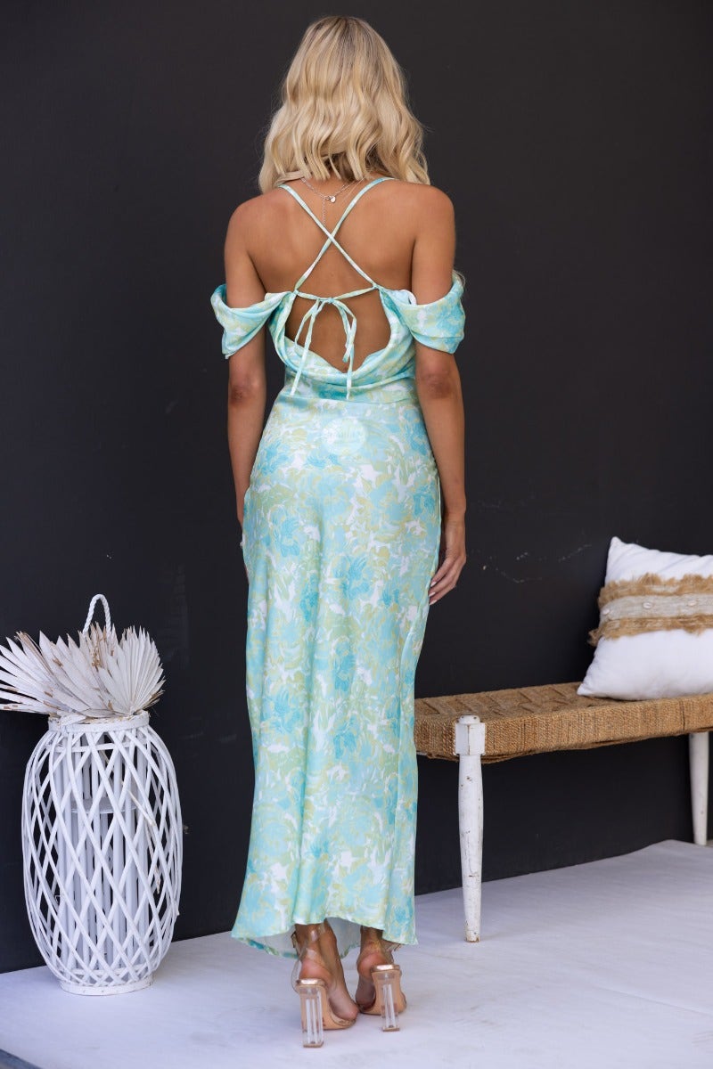 Back view of a Jiah Maxi Dress in multi-colour with adjustable tie straps and cap sleeves, model showcasing elegant fit.