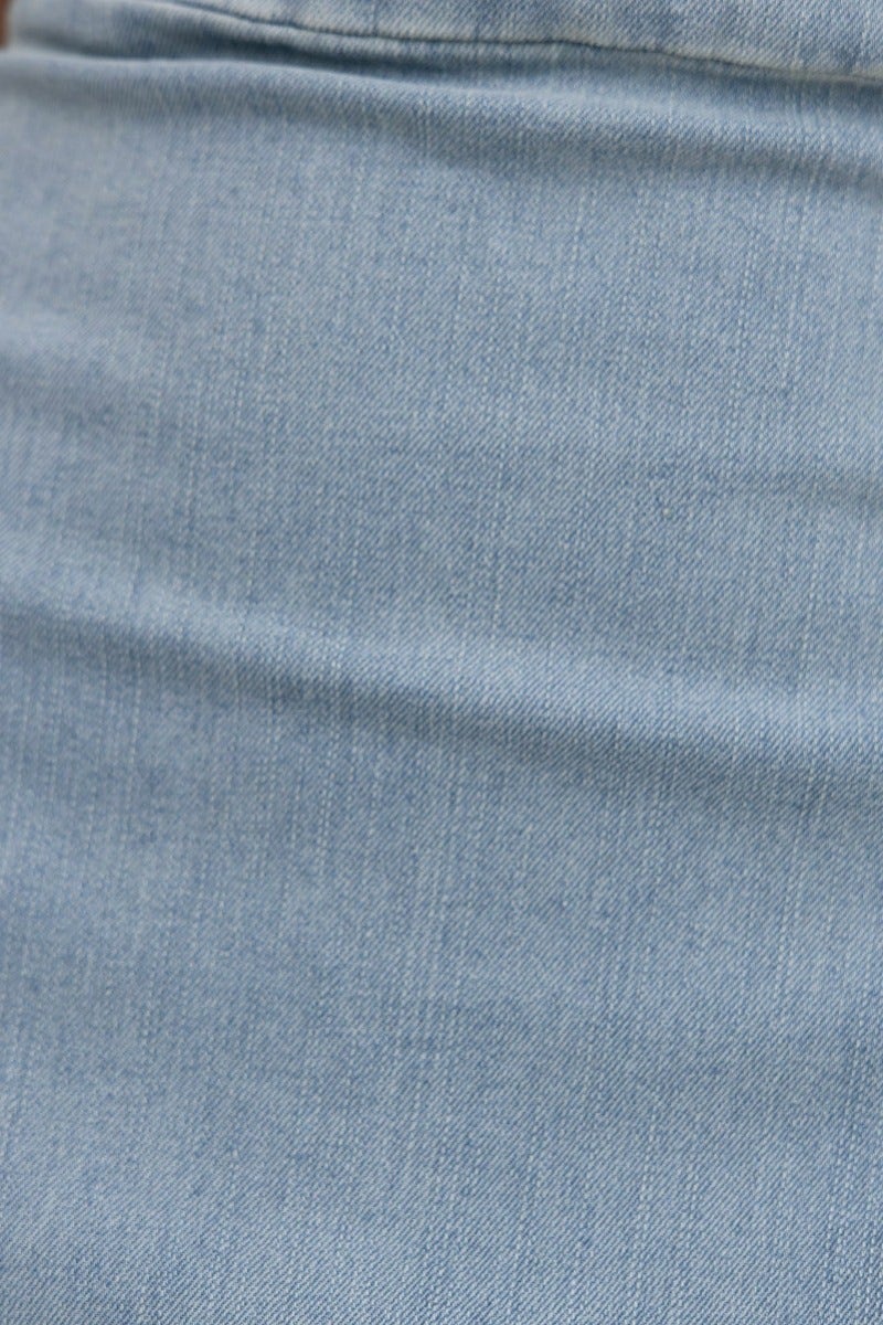 Close-up of soft light blue denim fabric showcasing texture, ideal for a stylish maxi dress.