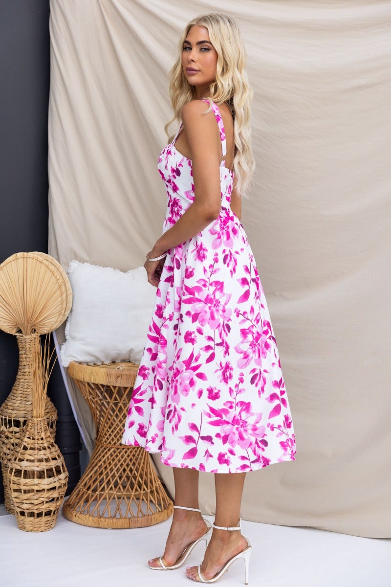 Quiet Days midi dress with floral print, adjustable straps, and split front, worn by a model against a neutral backdrop.