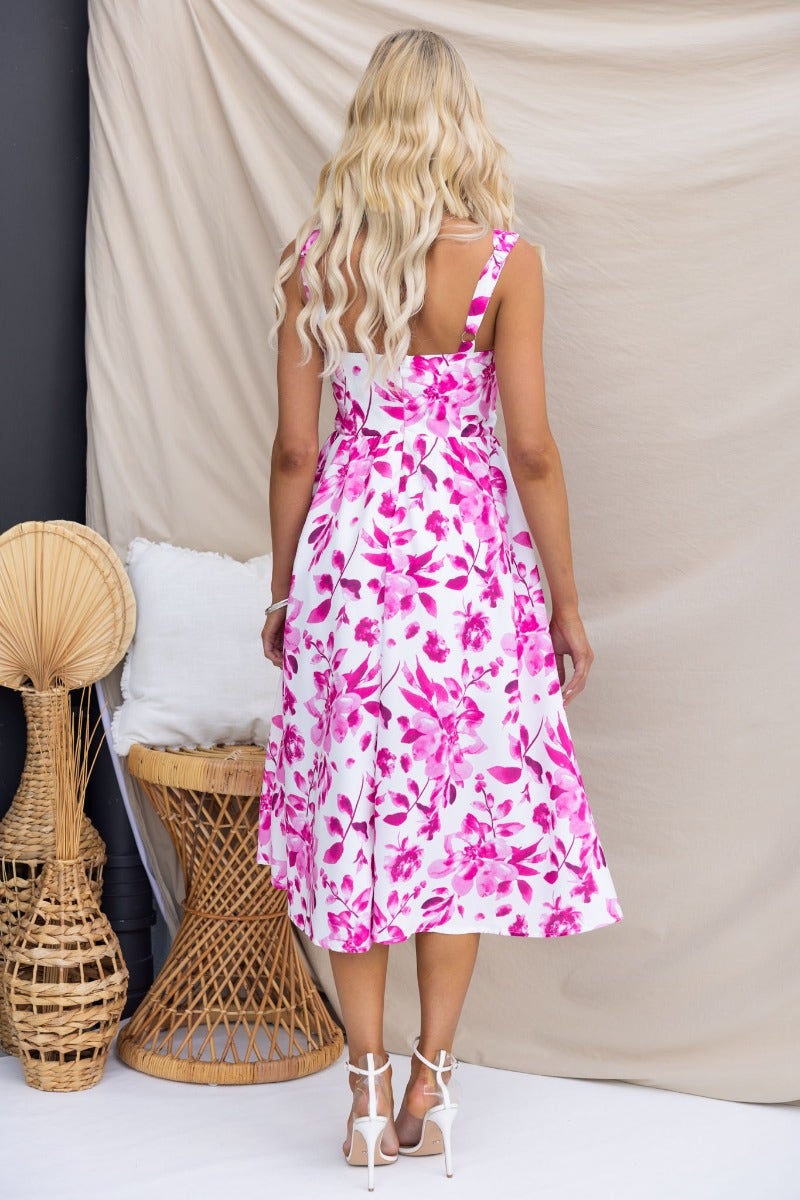 Back view of a floral print midi dress with adjustable straps and a split front, perfect for summer outings.
