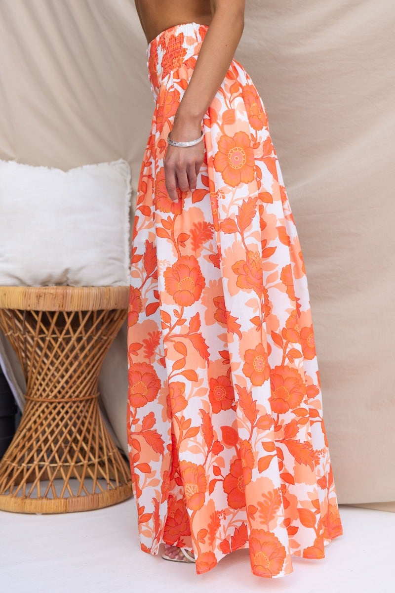 Idella Maxi Skirt with floral print, elastic waistband, and side split, styled with a chic boho aesthetic.