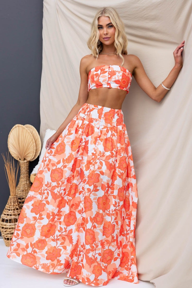 Model wearing Idella floral print maxi skirt and matching crop top against a neutral backdrop.