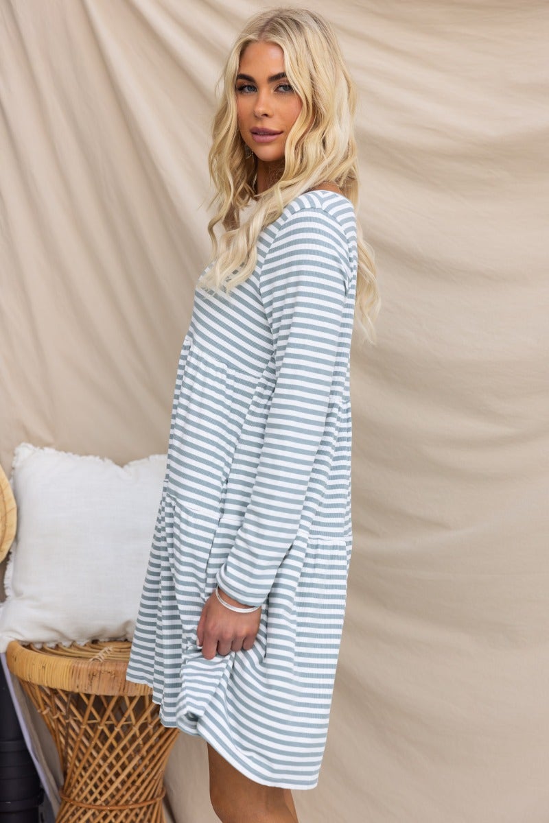 Sorrell Dress in ribbed material with V-neckline and pockets, featuring a relaxed fit and striped pattern.