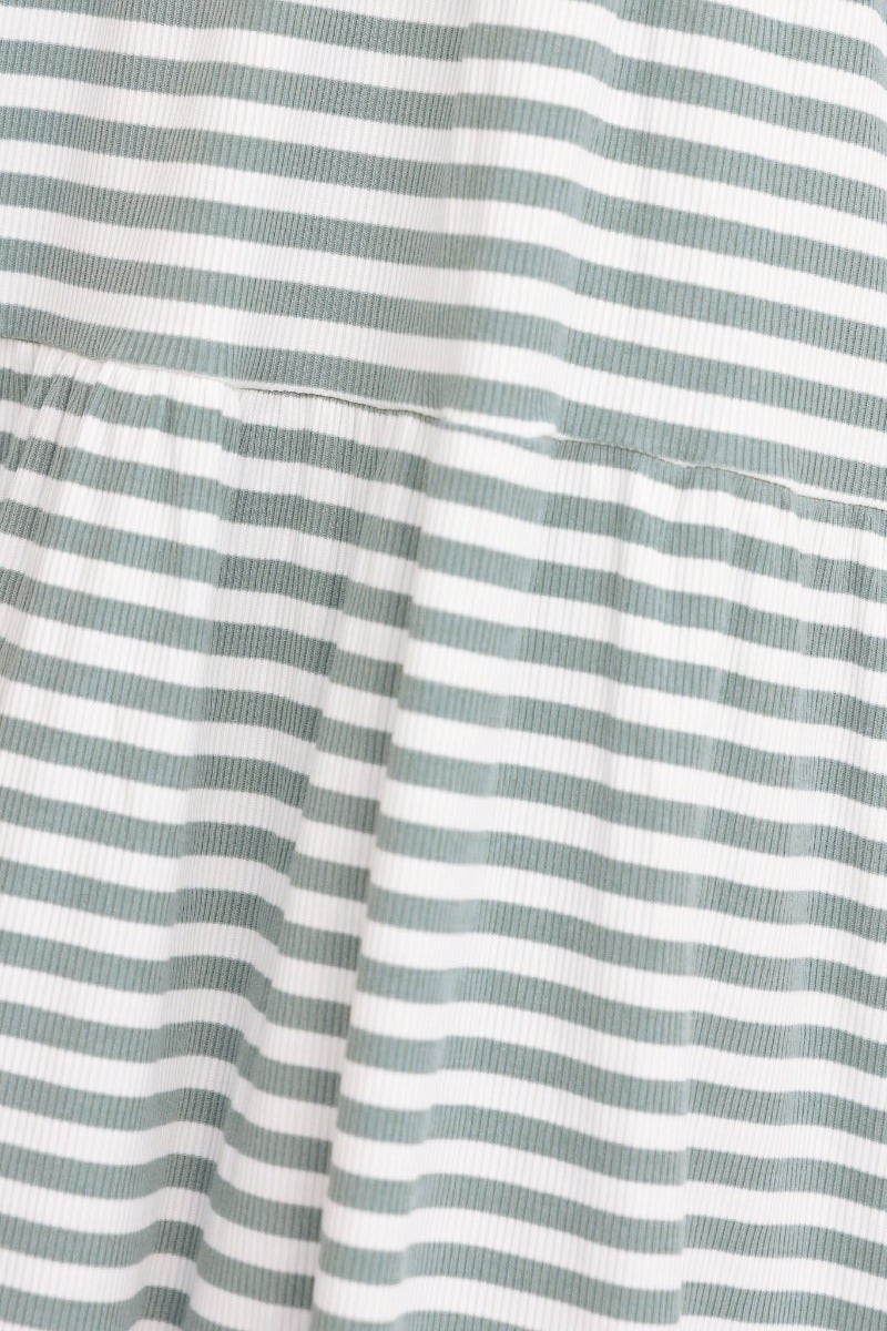 Close-up of the ribbed striped fabric of the Sorrell Dress in soft green and white, showcasing its texture.