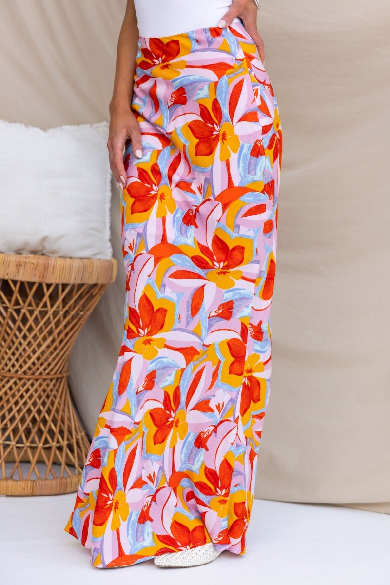 Floral print Heartful maxi skirt with vibrant orange and pink flowers, styled with a fitted waist and flowing silhouette.