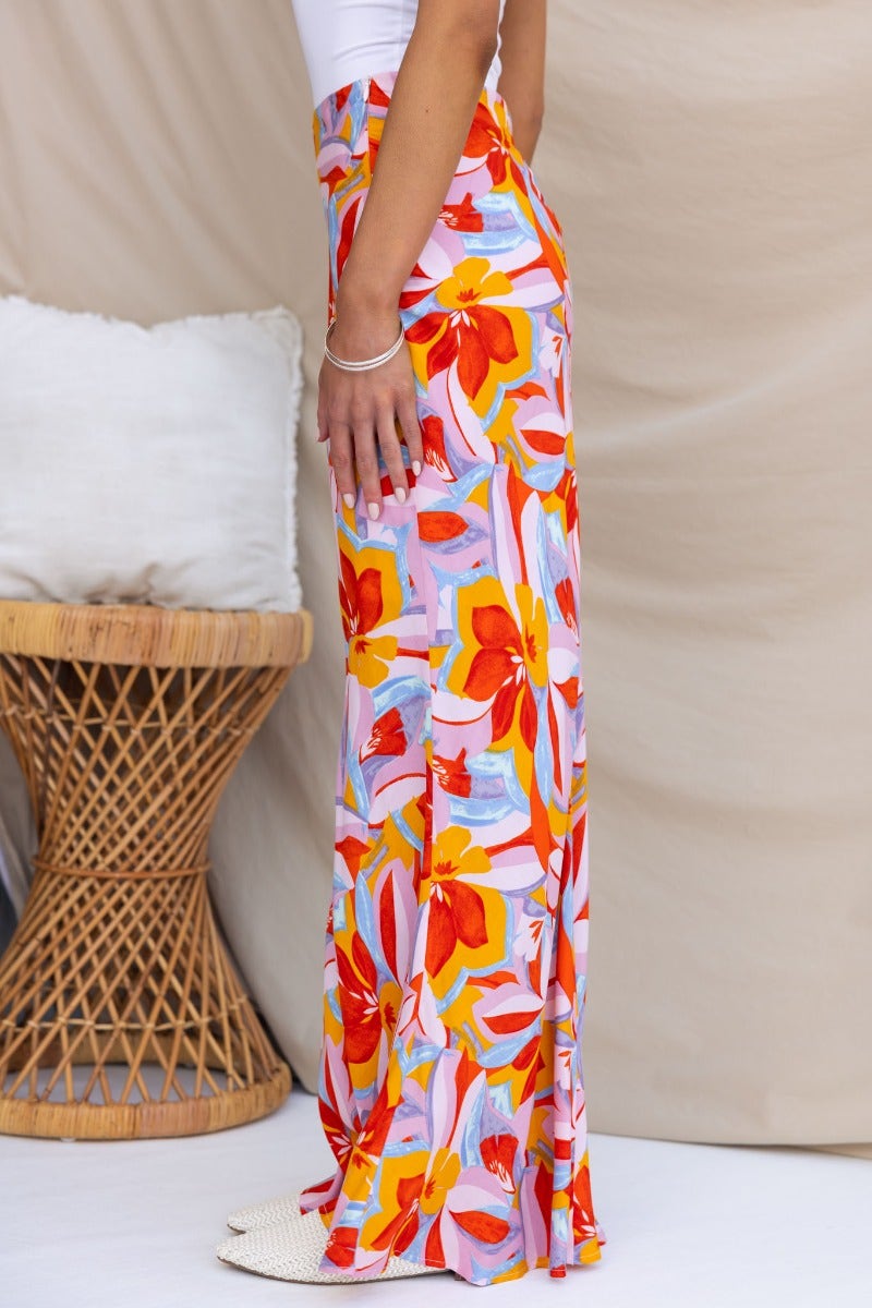 Side view of Heartful Maxi Skirt featuring vibrant floral print, styled with a fitted top. Perfect for summer outings.