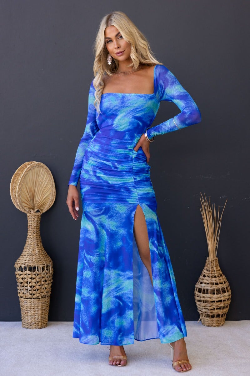 Keziah Maxi Dress in blue multi-colour with cross-over back detail and high split, styled on model