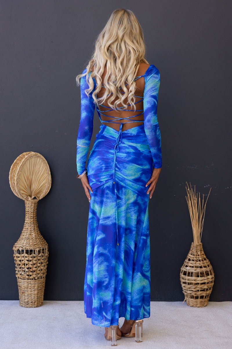 Model wearing Keziah Maxi Dress with multi-colour pattern, showcasing back tie detail and high split on a neutral background.