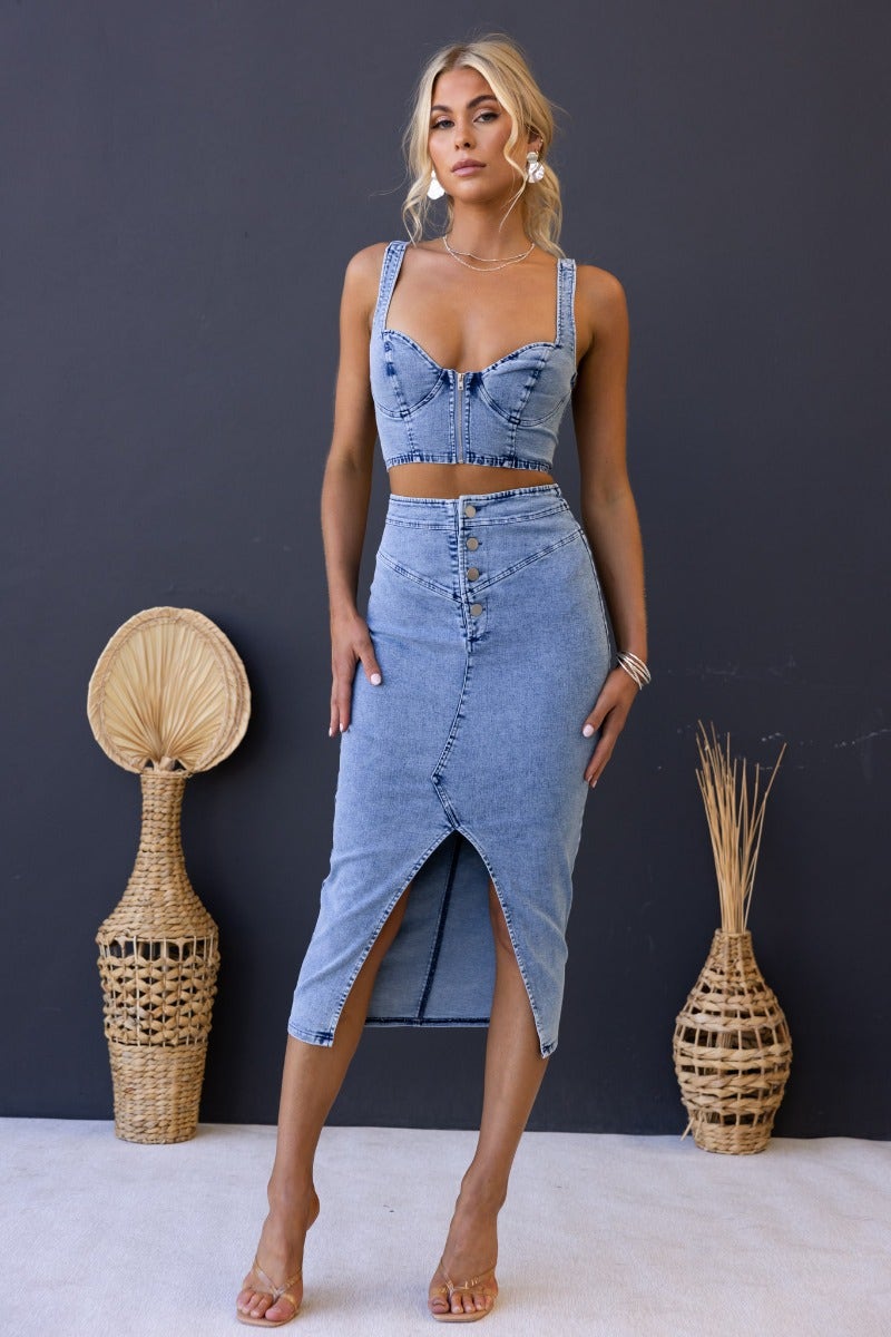 Model wearing Genevieve Midi Skirt, a denim high-split skirt with button-up front, styled with matching crop top.