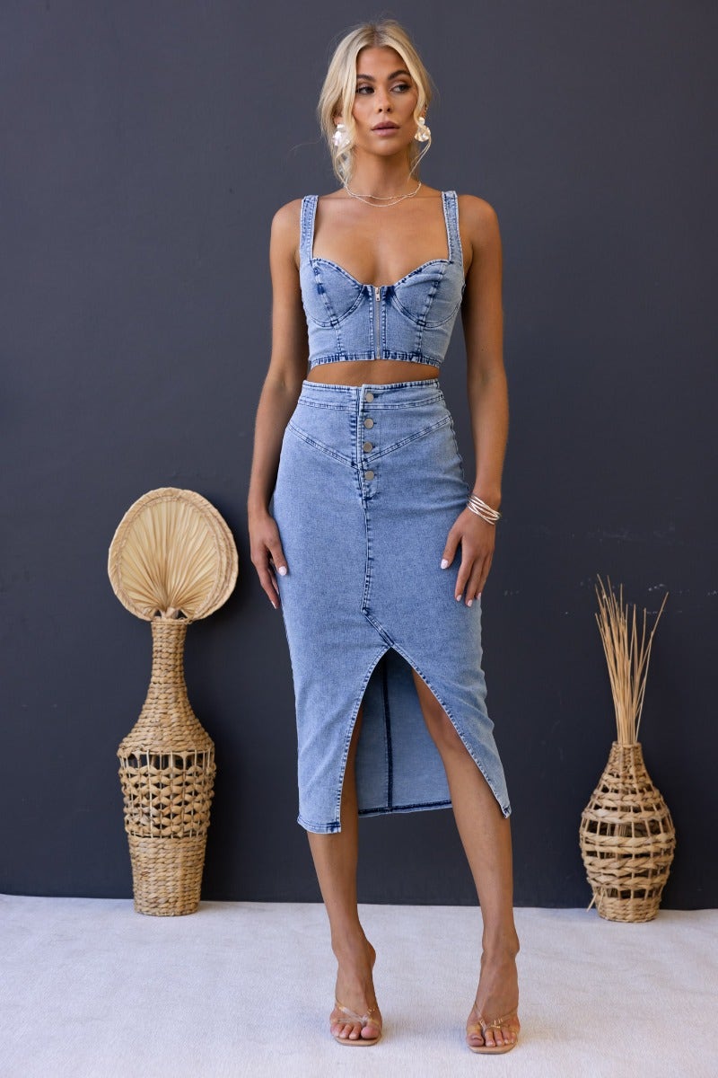 Genevieve Top in denim with adjustable straps, zip bust, and cropped fit, styled for an elegant look.