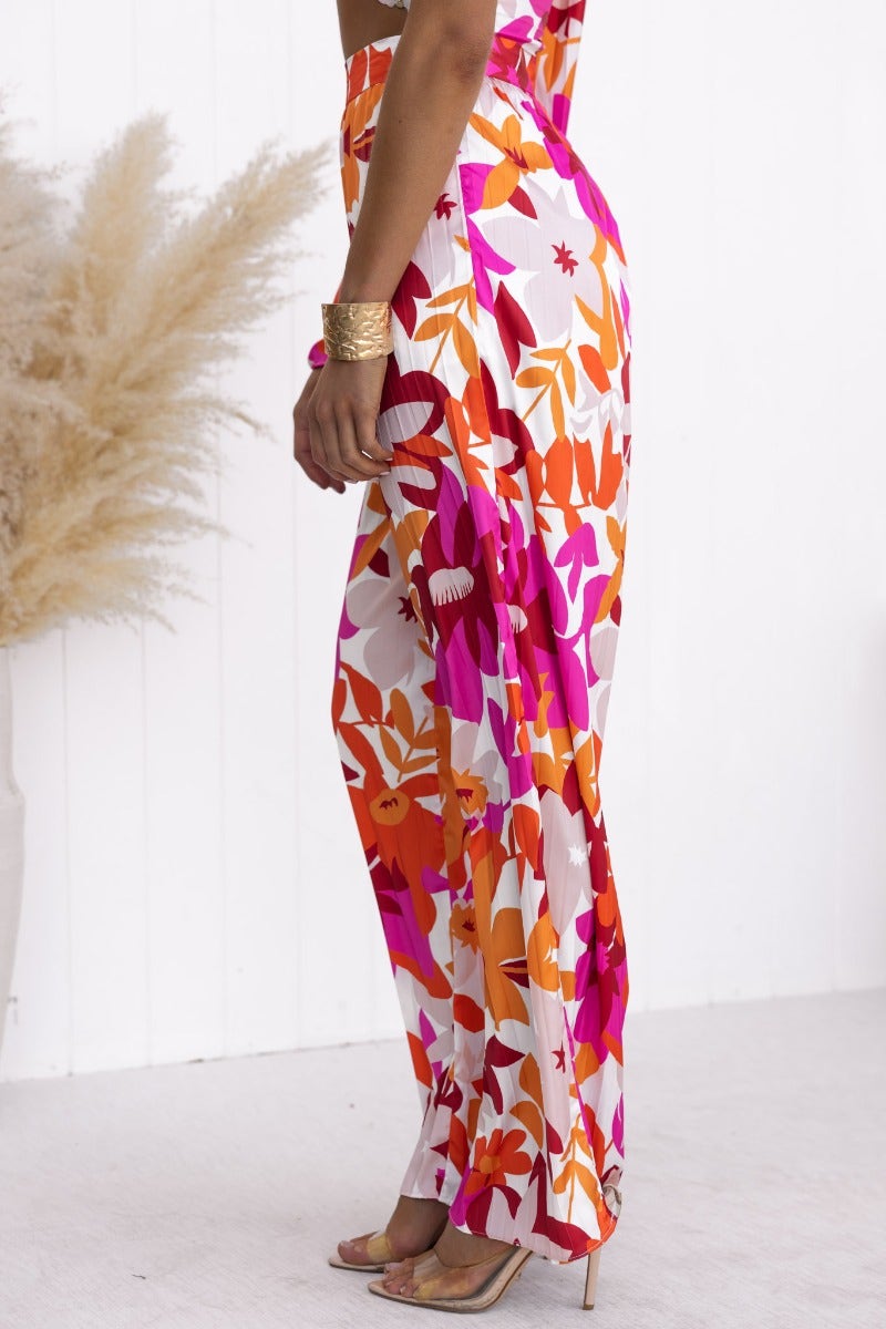 Kira Set floral print one-shoulder top and pants ensemble with twist detail, side zips, and wide sleeves.