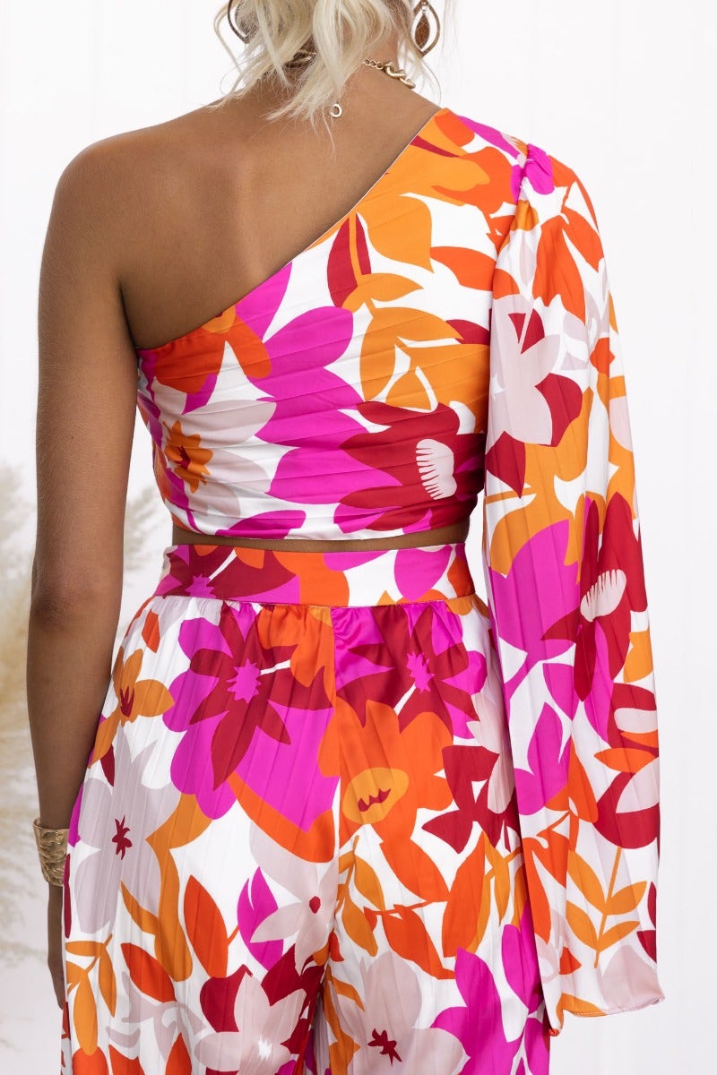 Kira Set floral print one-shoulder top with twist detail and wide sleeve in vibrant colors, showcasing back view.