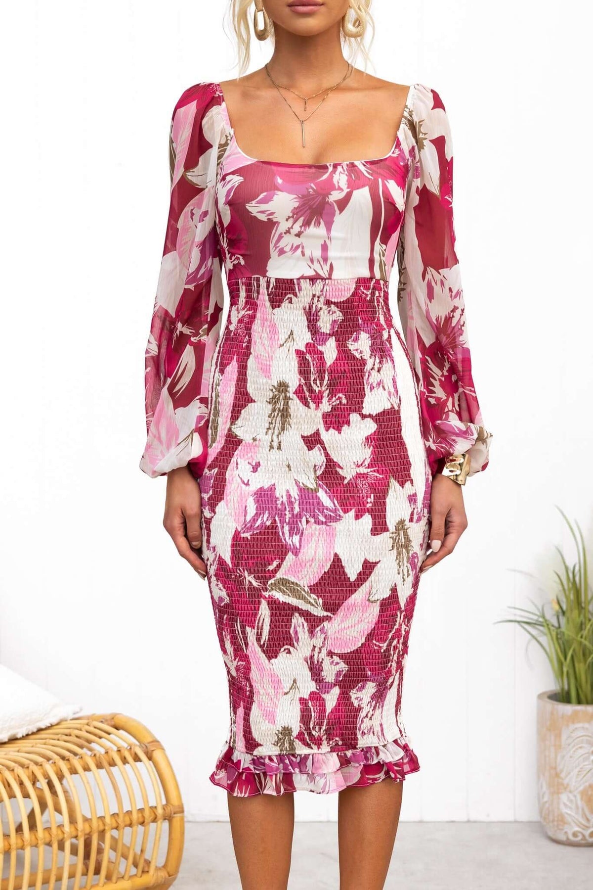 Model wearing the Naples Midi Dress featuring floral patterns, elastic sleeves, and a fitted silhouette.