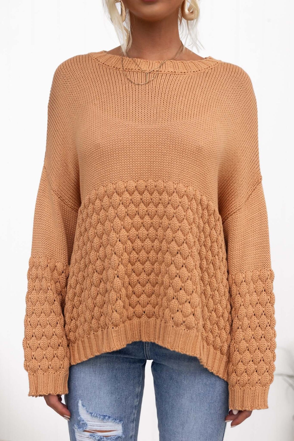 Hamden Jumper in warm orange knit with textured sleeves, styled with casual denim jeans.