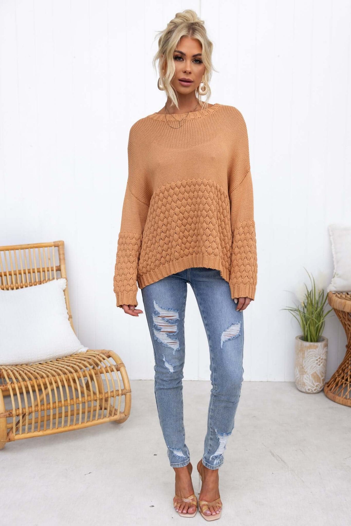 Model wearing a cozy Hamden Jumper in tan with relaxed fit, paired with ripped jeans and sandals.