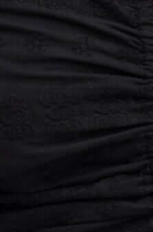Close-up of black Anglaise material with ruching detail, highlighting the texture and lined finish.