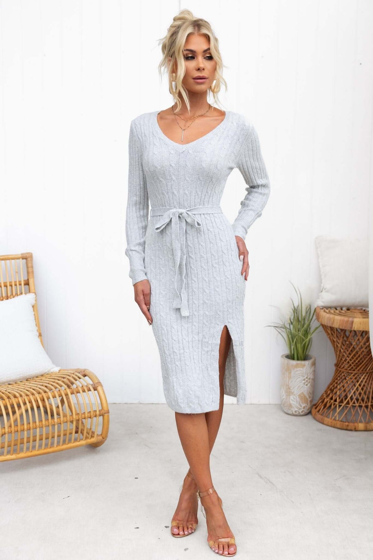 Light grey Raton Midi Dress with a V-neckline, ribbed knit, removable tie, and side slit, styled with sandals.