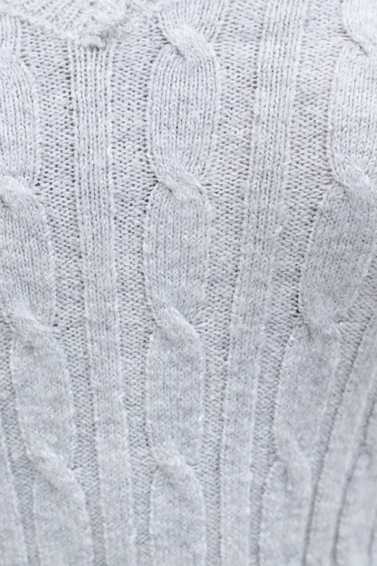 Close-up of soft, ribbed knit gray fabric with cable pattern, ideal for knitwear products.