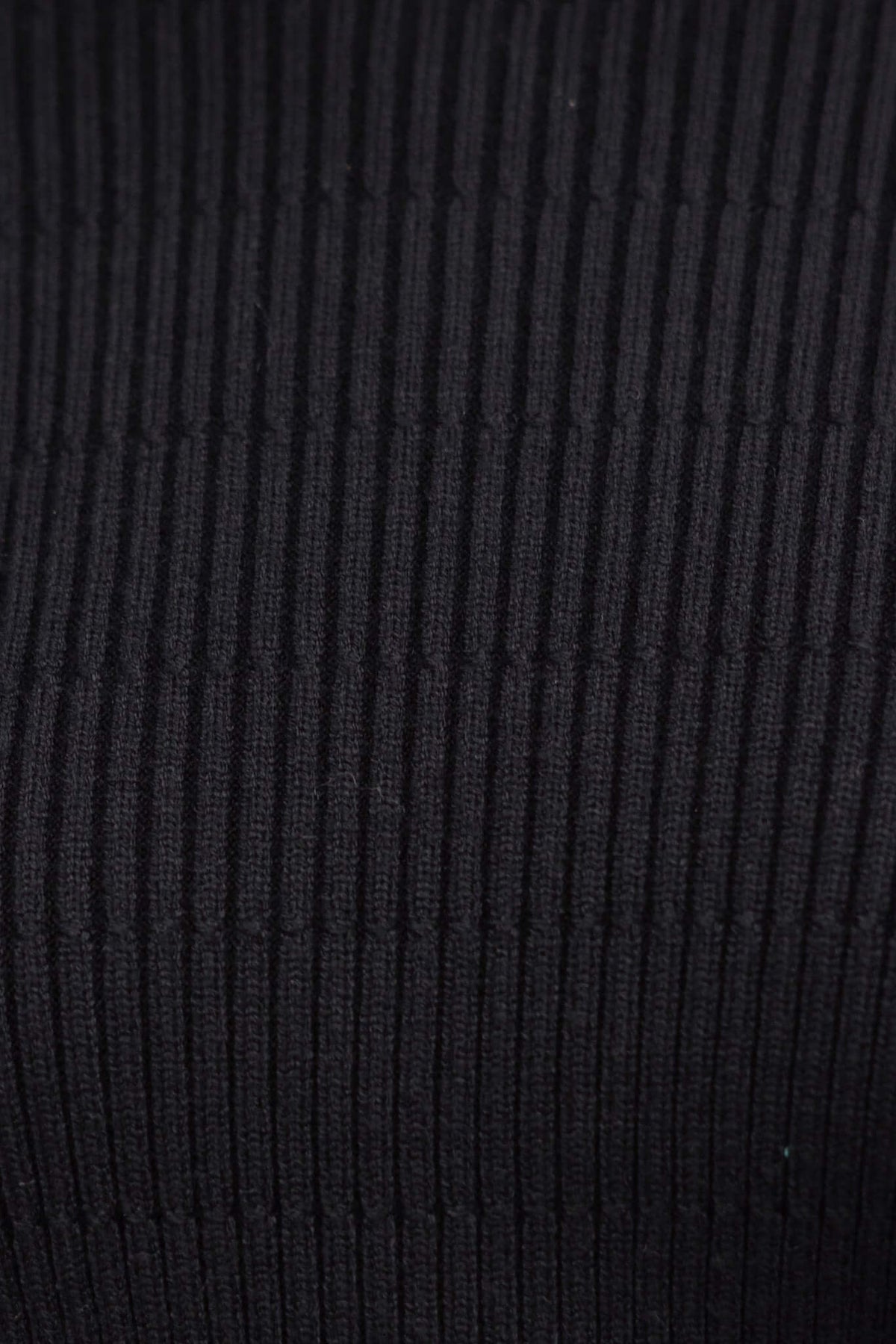 Close-up of ribbed knit black fabric, showcasing texture and stretch of Wheaton Dress.