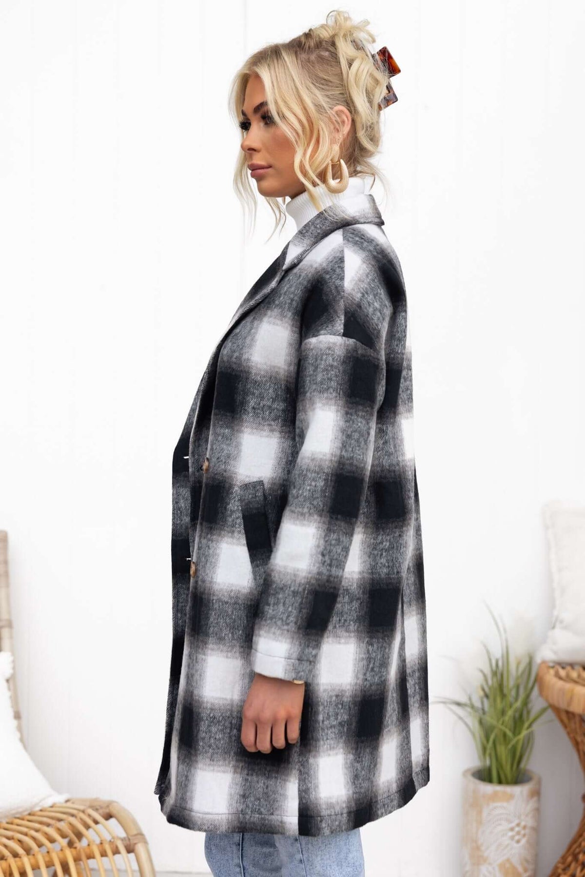 Tiffin coat in black and white check pattern, featuring lapel collar and button-up front.