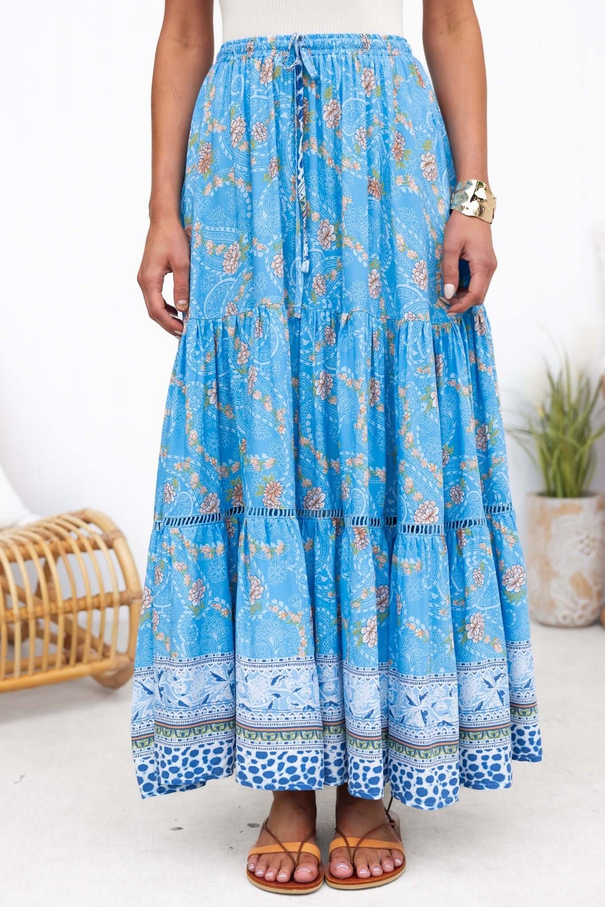 Darian Maxi Skirt in blue floral print, featuring a mid-high waist and elastic drawstring waistband, perfect for summer wear.