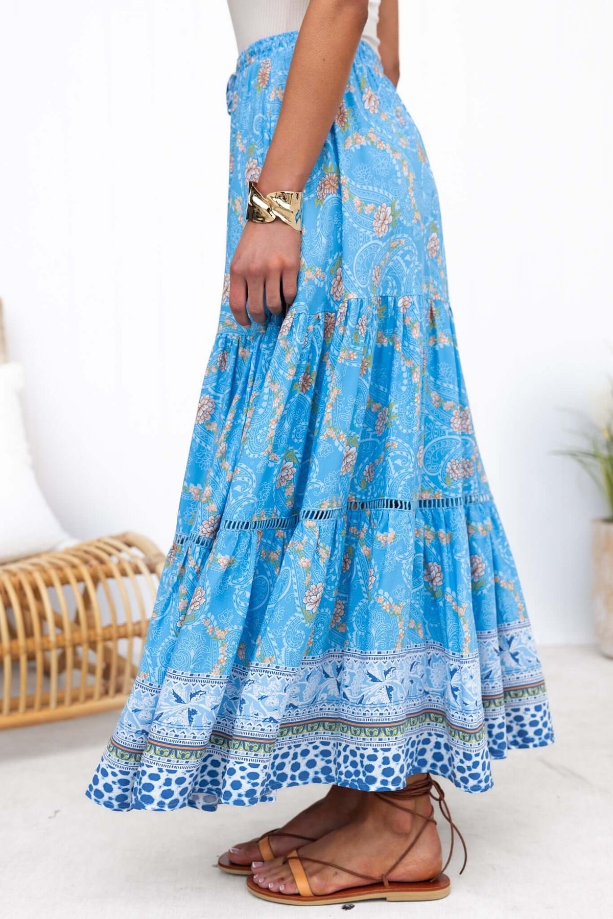 Darian Maxi Skirt in blue floral print, featuring a tiered design and mid-high waist with elastic waistband.
