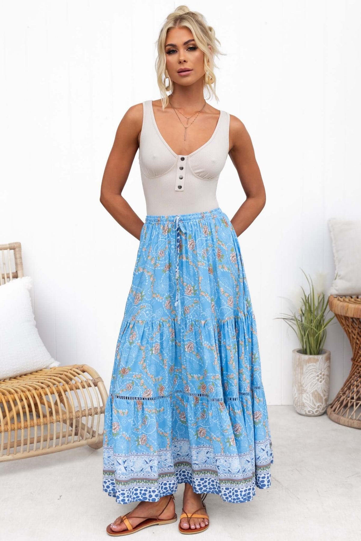 Nola Bodysuit displayed under a flowy blue patterned skirt, featuring faux buttons, a stylish summer outfit.