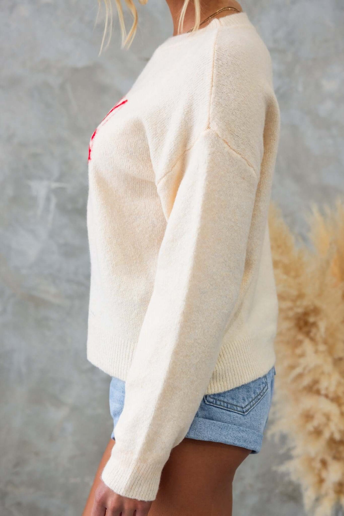 Side view of Tommy Jumper in cream with 'Spicy Margs' print, perfect for a relaxed fit and casual style.