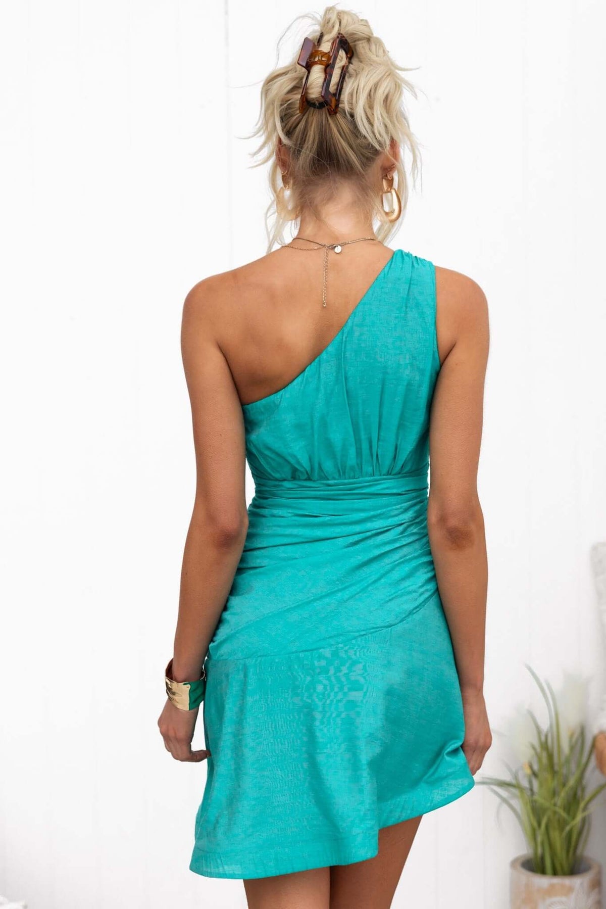 Back view of the turquoise Deep Thoughts Dress featuring a one-shoulder design and ruched detailing.