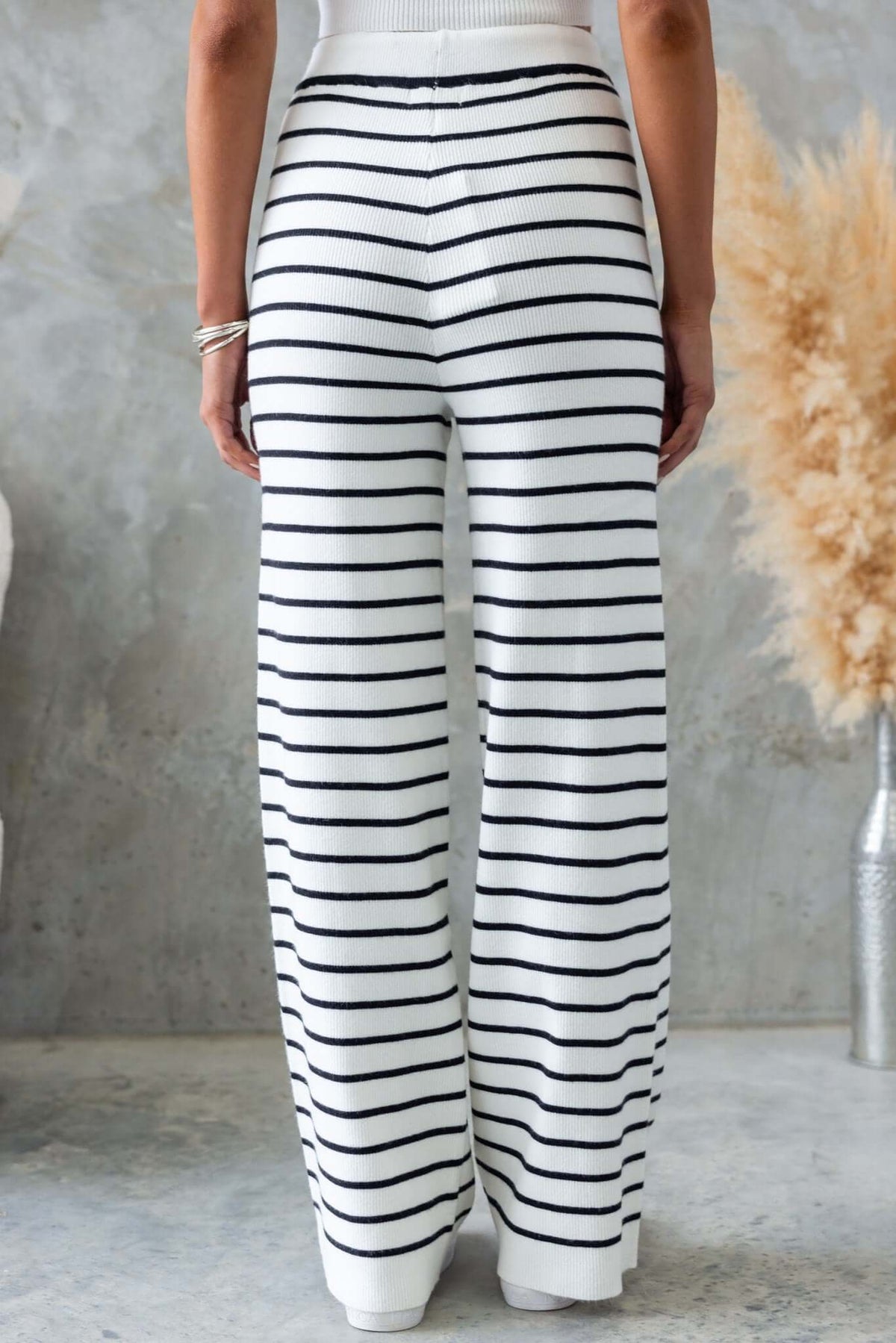 Back view of Nowlan Pants featuring mid-high waist, elastic waistband, and stylish black and white stripe design.