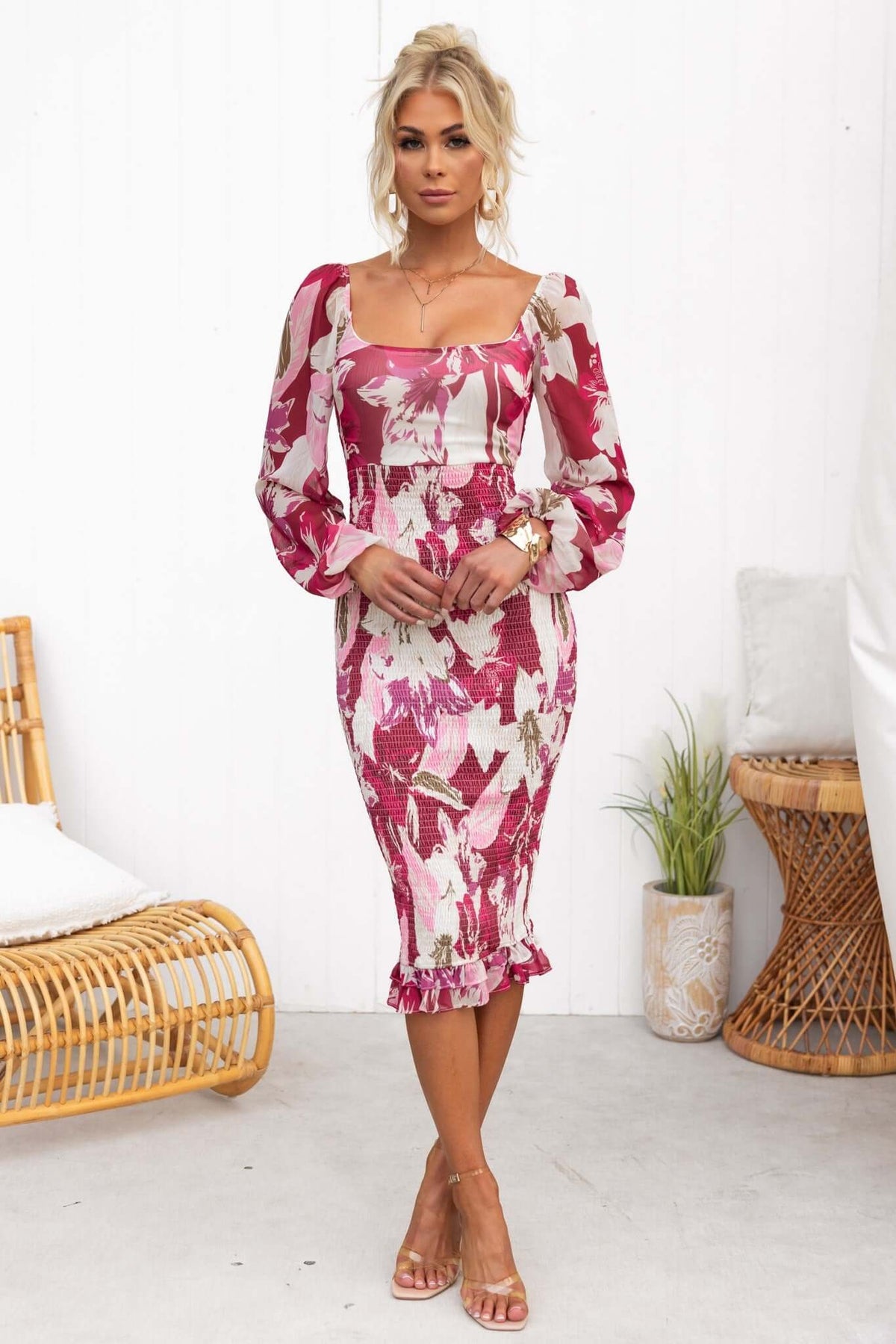 Model wearing the Naples Midi Dress with floral print, elastic sleeves, and fitted design.