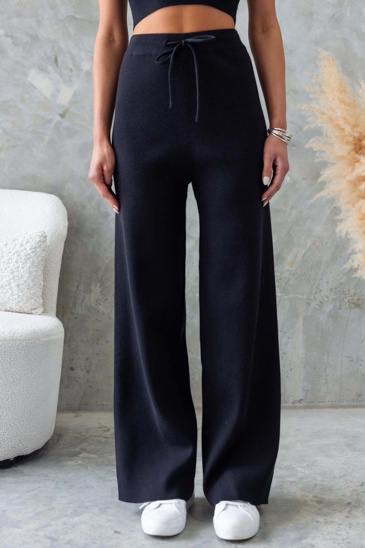 Nowlan Pants: Black drop crotch trousers with elastic waistband and drawstring for comfort and style.