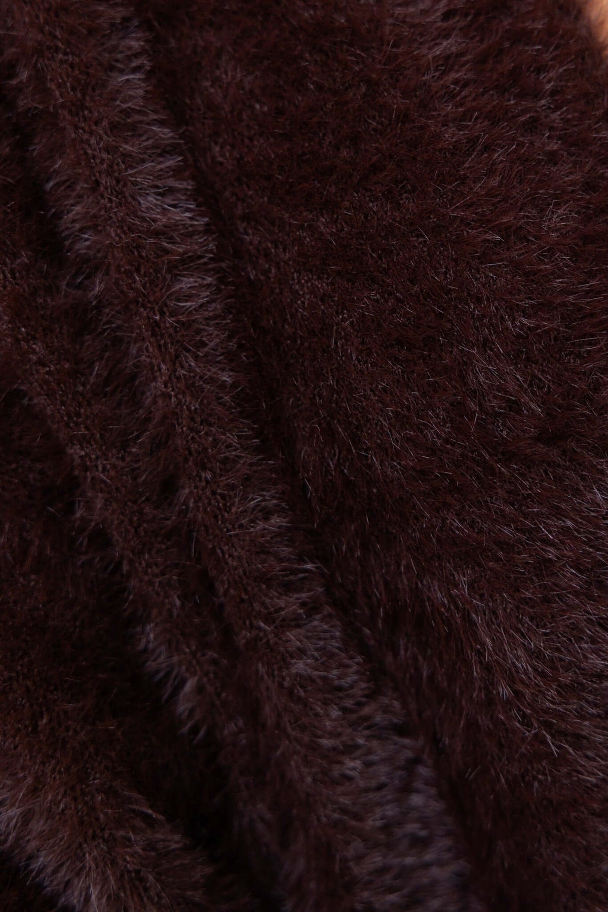 Close-up of dark brown fluffy knit fabric, highlighting the luxurious texture of the Salem Cardigan.