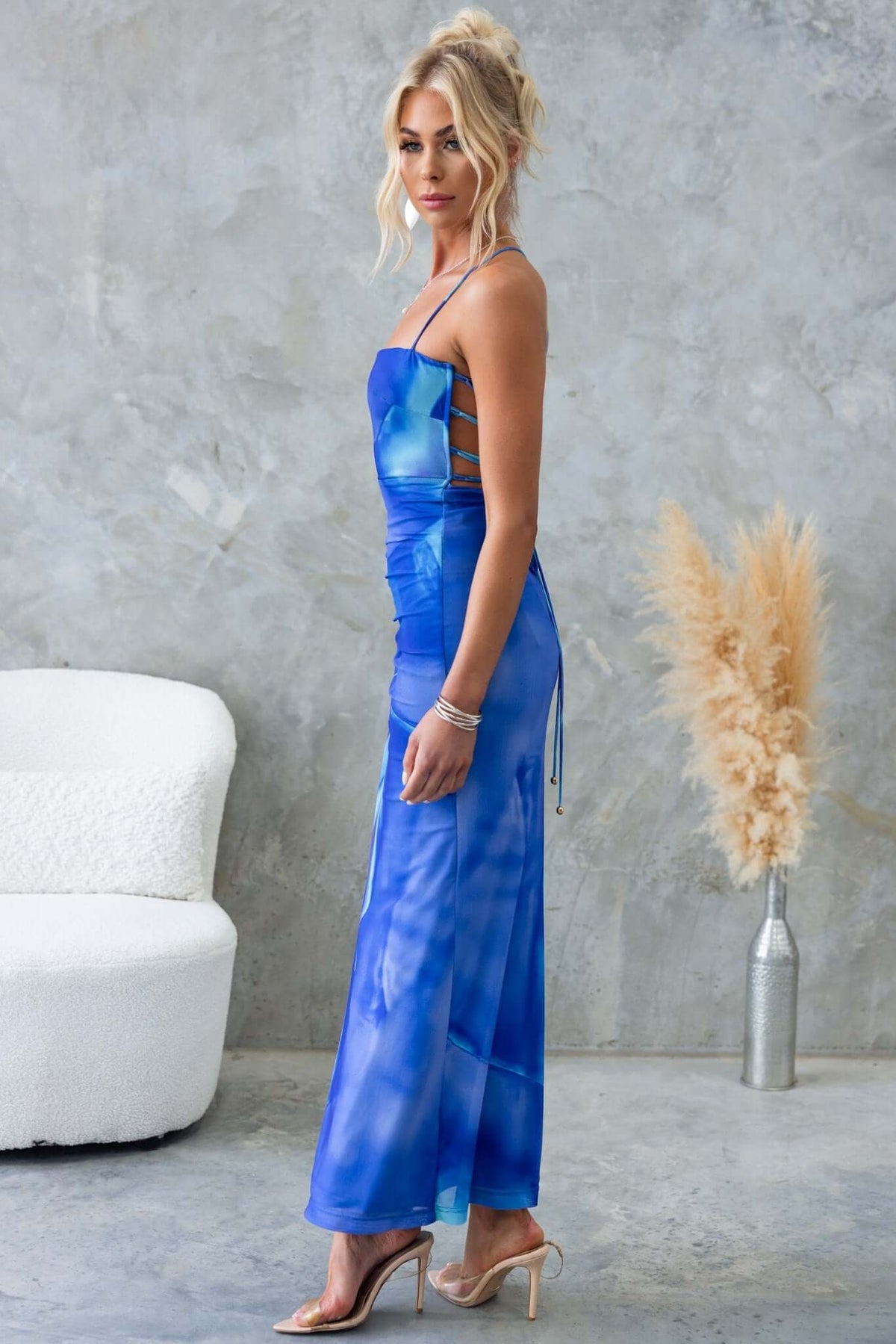 Model wearing the Orono Maxi Dress in blue, showcasing adjustable straps and a stylish side split.
