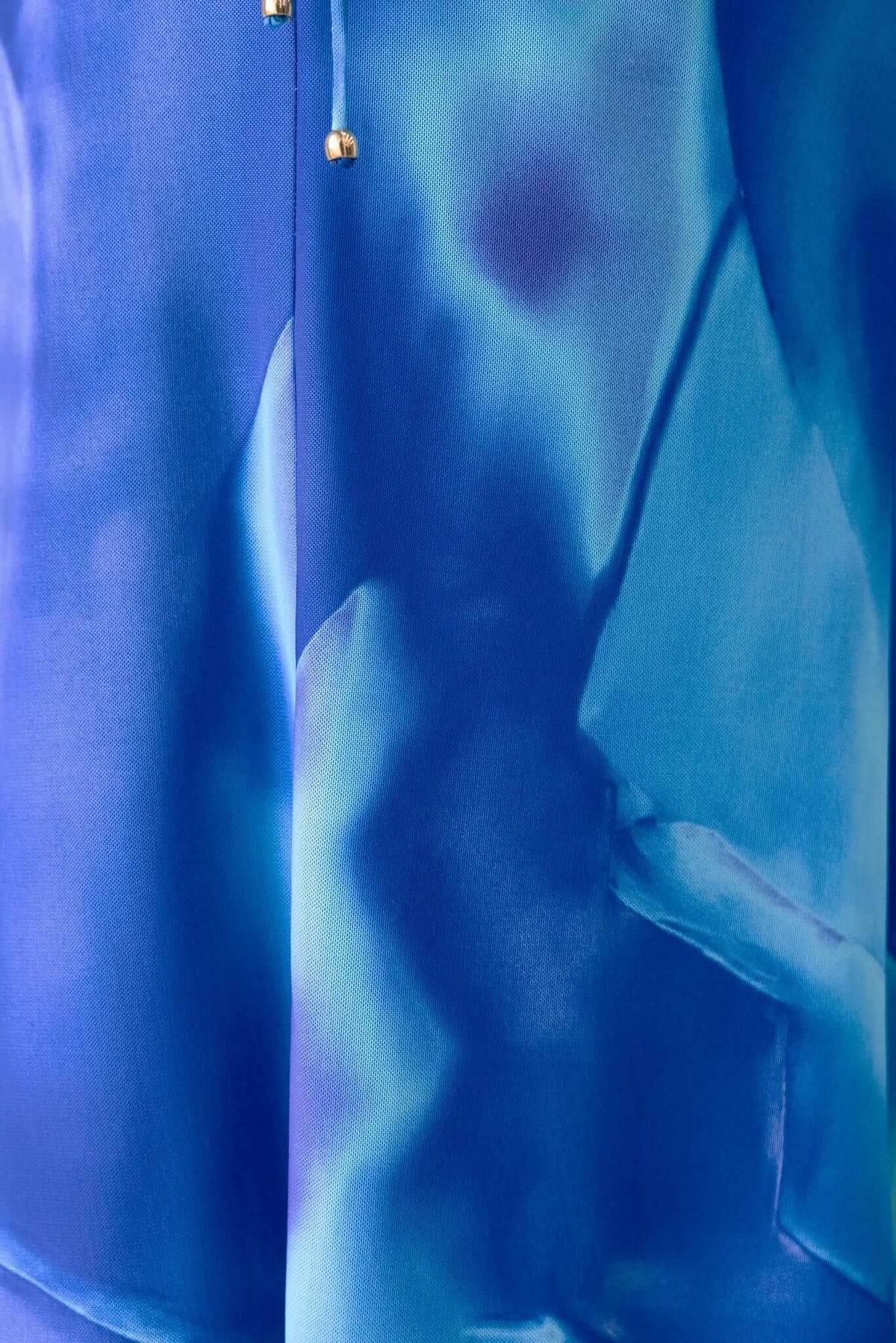 Close-up of the blue Orono Maxi Dress showcasing its vibrant fabric and unique design details.
