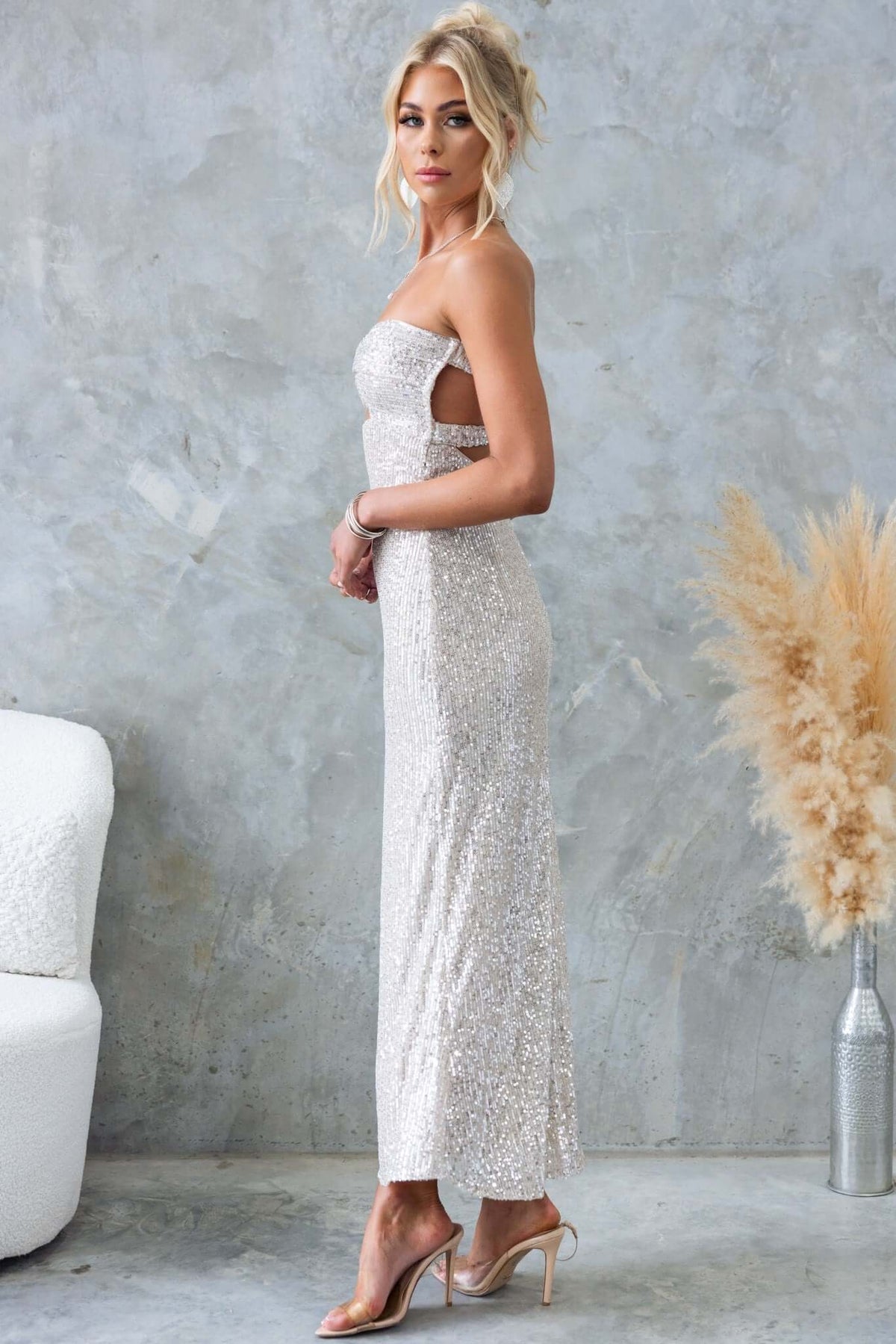 Elegant Kileen Maxi Dress in sequins, featuring a strapless design and cut-out details, styled for glamour.