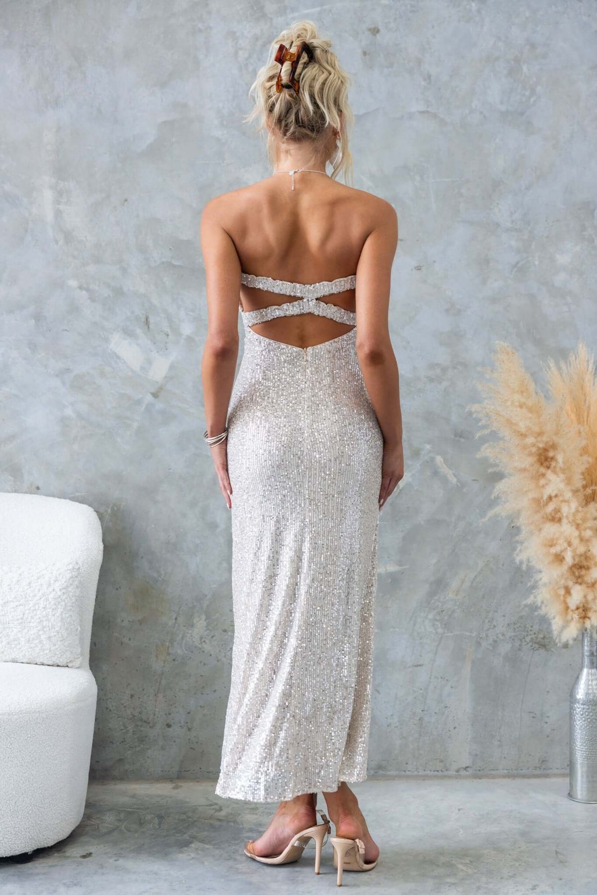 Back view of Kileen Maxi Dress featuring sequins, strapless design, and crisscross detail, showcasing elegance and style.