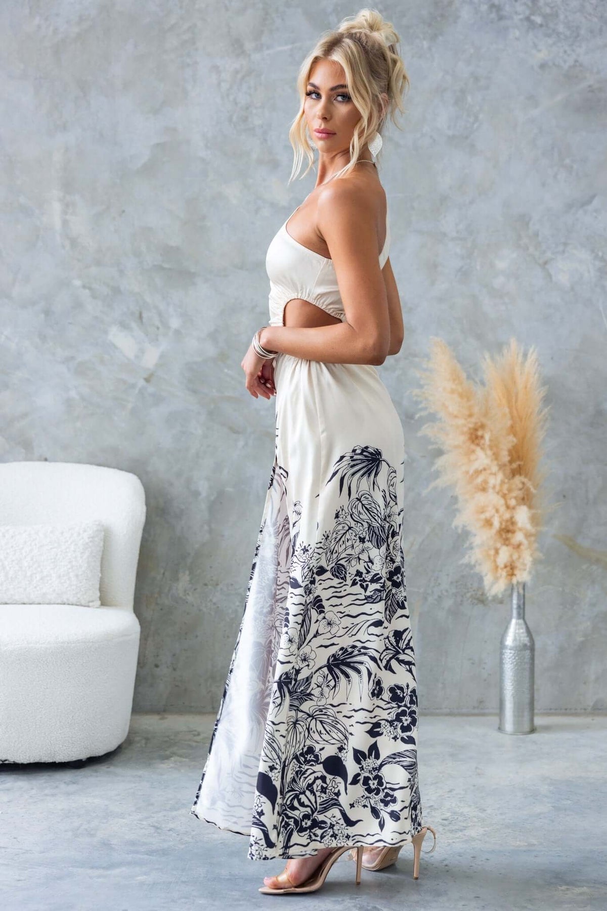 Carey Maxi Dress in floral print, one-shoulder with elastic waist cut-out, showcasing a high split, perfect for summer events.