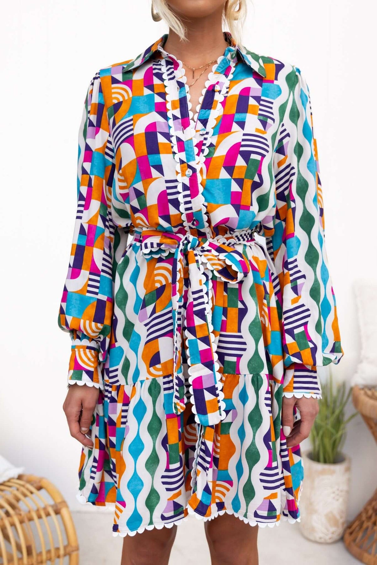 Colorful Bransley Dress with geometric patterns, collar, button-up front, and removable tie, perfect for a relaxed fit.