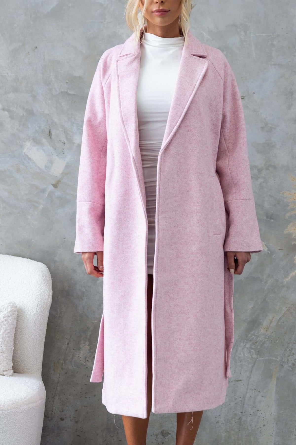 Jensen Coat in soft pink with longline fit, collar, lapel, pockets, and removable tie, styled by model.
