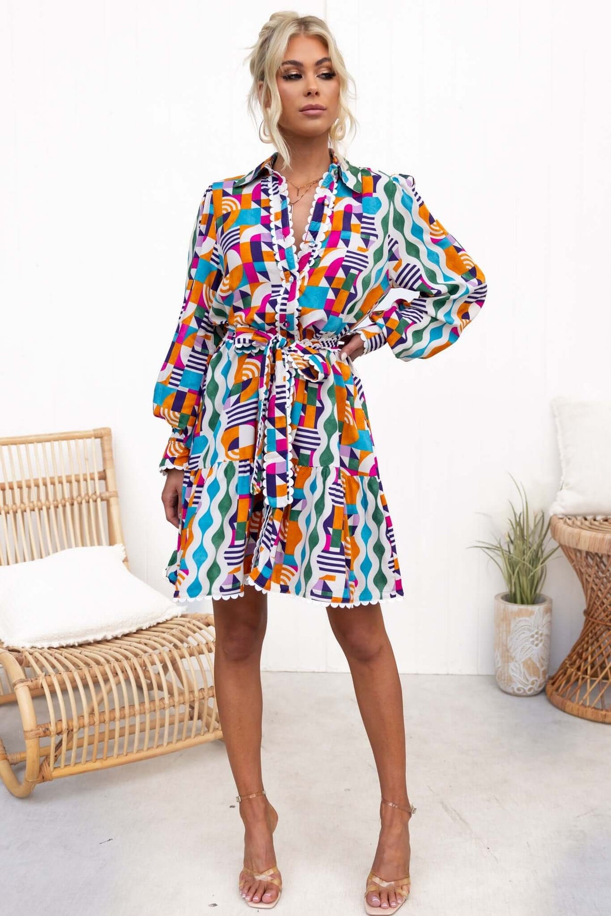Bransley Dress featuring vibrant patterns, button-up front, and removable tie, styled in a relaxed fit, model wearing size 6/XS.